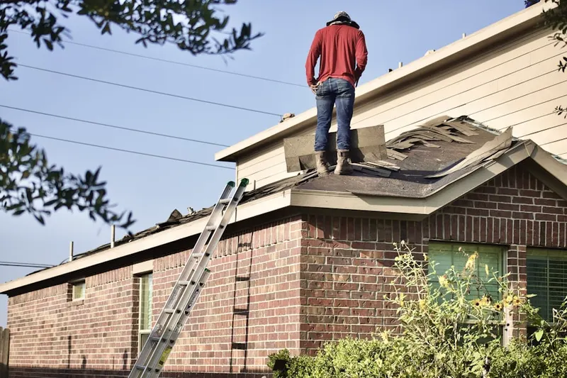 Professional roofer working on a residential roof in Oakdale Manor